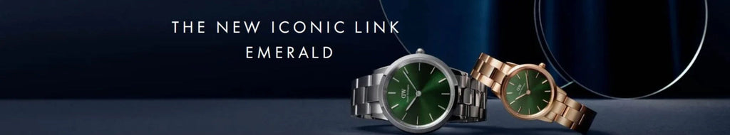 text saying "The New Iconic Link Emerald" with two watches with green dials