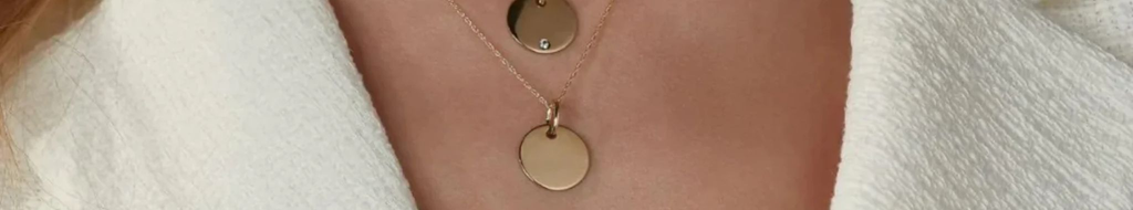 Close up of blank personalisable disc pendant on woman's neck