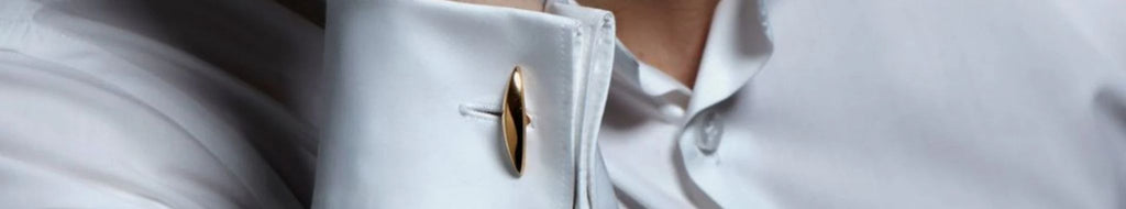 Close-up of mans cufflink with white shirt