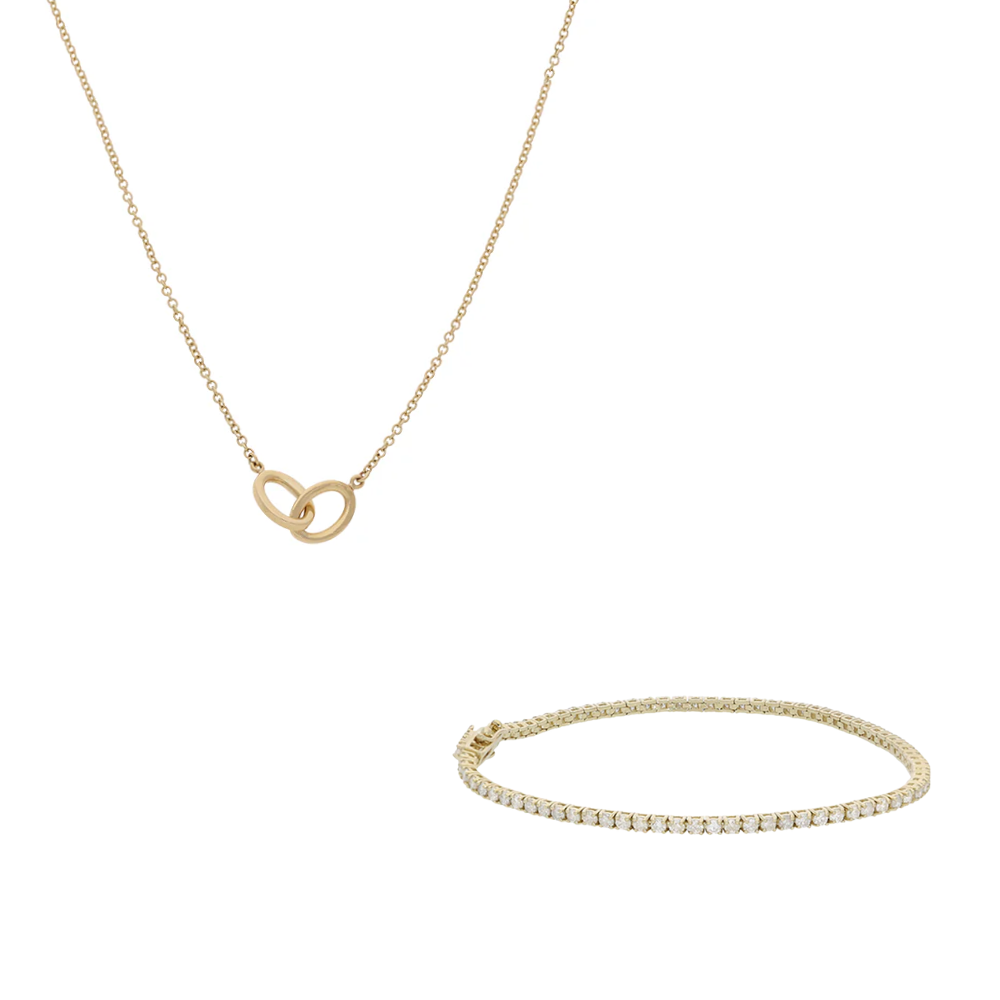 Gold necklace and bracelet set on a white background