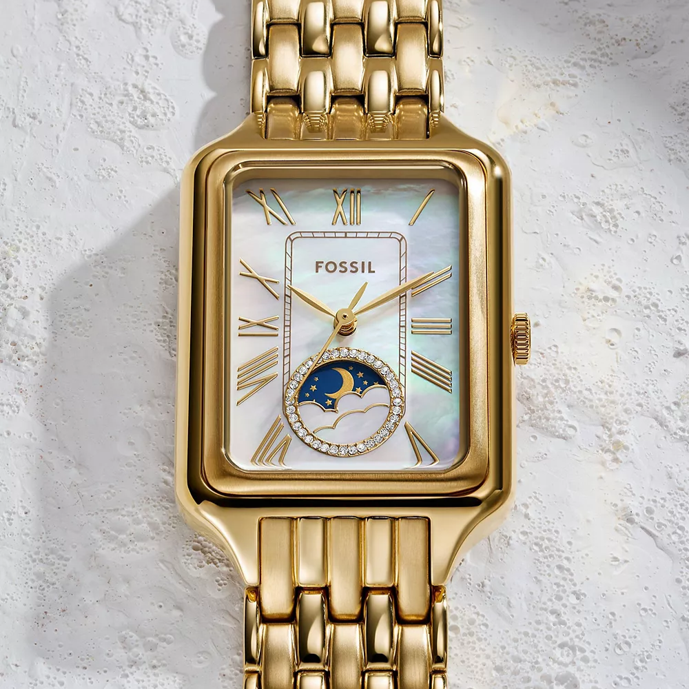 Gold Fossil watch on a light gray background