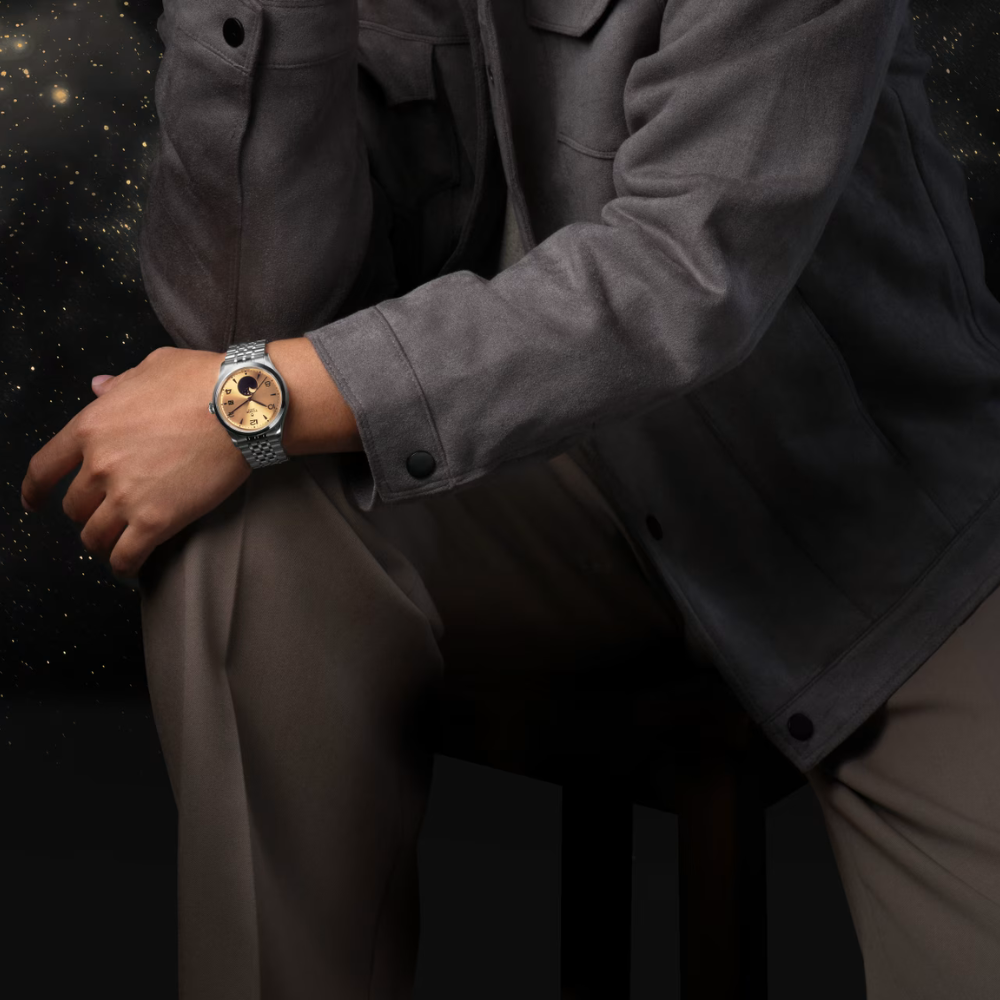 Person wearing a watch with a dark background