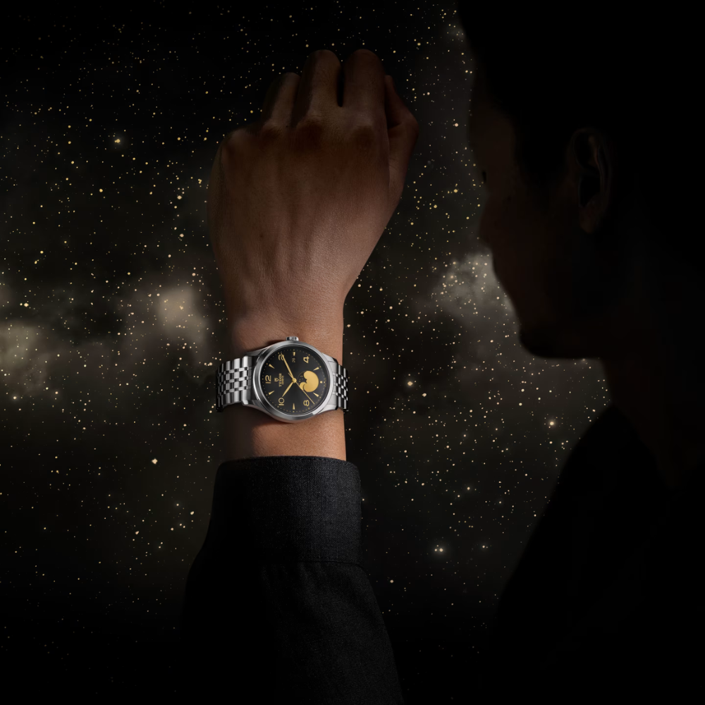 Person wearing a watch with a starry night sky background